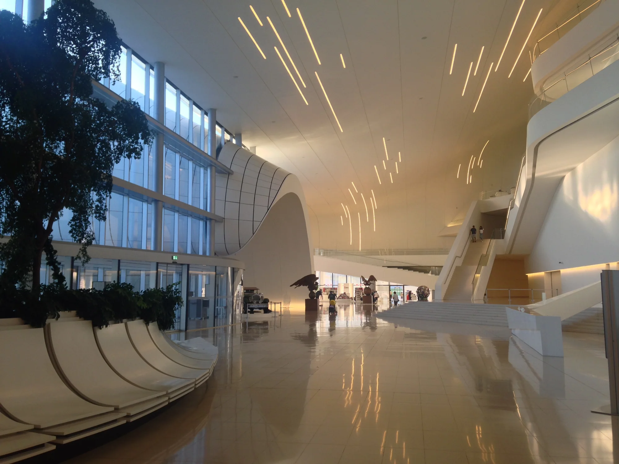 A white, continuously curving interior with a long ribbon of ceiling light.